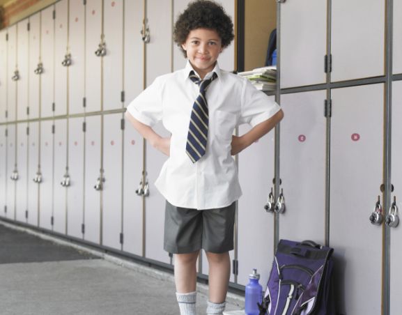 Primary school child in front of lockers